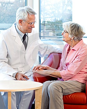 Physician consulting with an elderly woman.