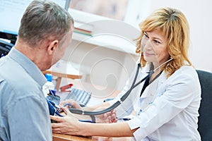 Physician doctor is checking the blood pressure of the patient