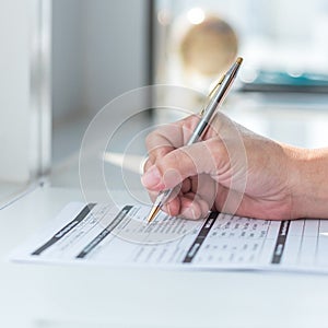 Physician doctor writing on medical health care record, patients discharge, or prescription form paperwork in hospital clinic