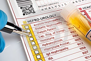 Physician filling medical form of urianalysis diagnostic