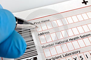 Physician filling out a medical form of diagnosis with patient d