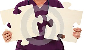 Physician Holding Puzzle Pieces