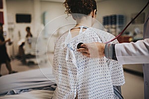 Physician listening to the lungs of a patient