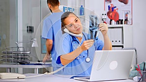 Physician nurse answering patient call by phone