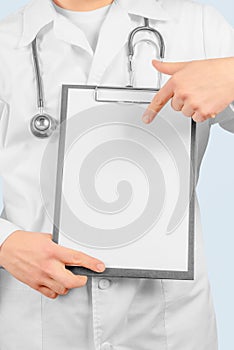 Physician is pointing on clipboard, copyspace