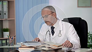 Physician reading medical books searching information about rare disease science