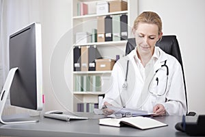 Physician Reviewing her Written Findings on Paper