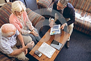 Physician showing medical statistics to senior couple