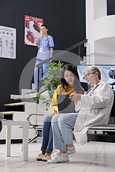 Physician specialist doing consultation with asian patient