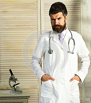 Physician with strict face ready to diagnose. Healthcare and treatment