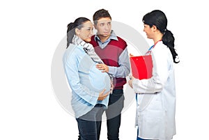 Physician talking with pregnant couple