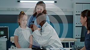 Physician using otoscope on small child to do ear examination