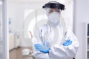 Physician wearing face shield and hazmat suit agasint contamination with coroanvirus