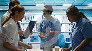 Physicians and radiologists analyzing x ray scans to create treatment plan