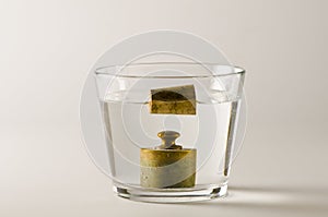 Physics. Heavy and light objects in water. photo