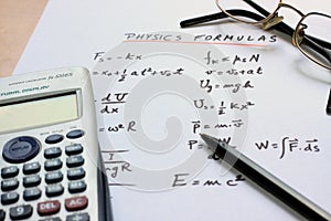 Physics formulas written on a white paper