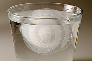Physics. Ice cube floating over water.