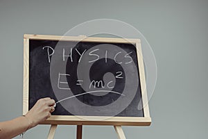 Physics word and formula E=mc2 on chalkboard