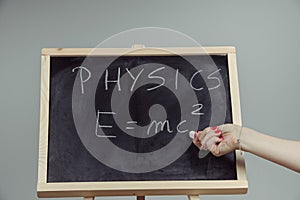 Physics word and formula E=mc2 on chalkboard