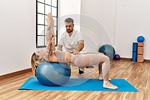 Physioterapist man giving rehab treatment to woman at the clinic