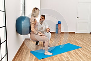 Physioterapist man giving rehab treatment to woman at the clinic