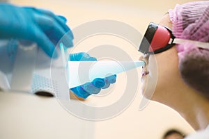 Physiotherapeutic procedure of the nasopharynx of a teenager tube quartz photo