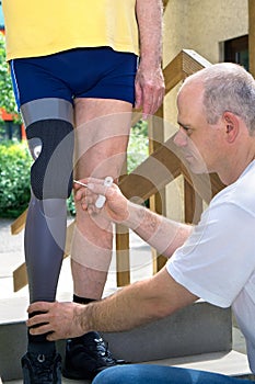 Physiotherapist adjusting prosthetic leg