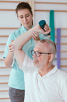 Physiotherapist assisting a senior patient