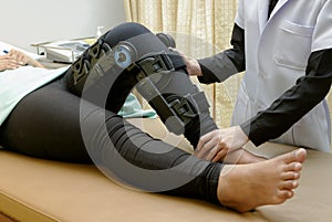 Physiotherapist do stretch exercises on patient`s leg, rehabilit