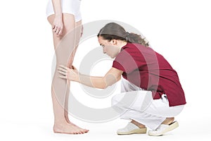 Physiotherapist doing a knee evaluation at a wpman