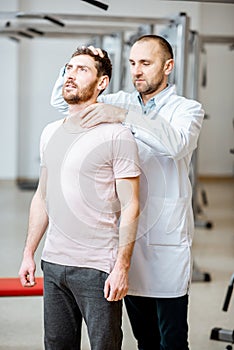 Physiotherapist doing manual treatment to a man