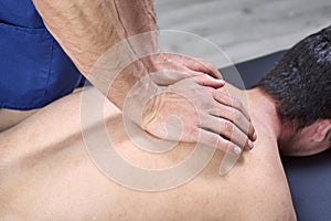 Physiotherapist doing a mobilization neck of female patient. Manual therapy. Neurological physical examination. Osteopathy,