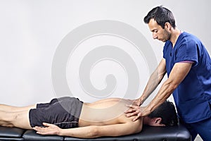 Physiotherapist doing a mobilization neck of female patient. Manual therapy. Neurological physical examination. Osteopathy,