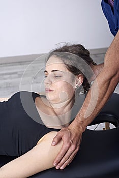 Physiotherapist doing a mobilization neck of female patient. Manual therapy. Neurological physical examination. Osteopathy,