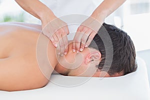 Physiotherapist doing neck massage to her patient