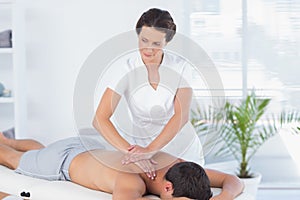 Physiotherapist doing shoulder massage to her patient