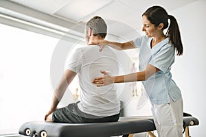 Physiotherapist doing treatment with patient in bright office