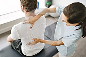 Physiotherapist doing treatment with patient in bright office