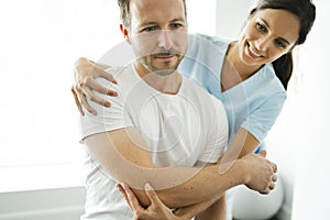 Physiotherapist doing treatment with patient in bright office