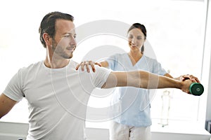 Physiotherapist doing treatment with patient in bright office