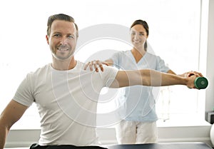 Physiotherapist doing treatment with patient in bright office