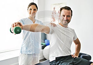 Physiotherapist doing treatment with patient in bright office