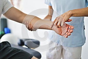 Physiotherapist doing treatment with patient in bright office