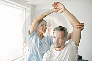 Physiotherapist doing treatment with patient in bright office