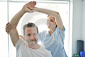 Physiotherapist doing treatment with patient in bright office