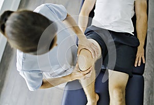 Physiotherapist doing treatment with patient in bright office