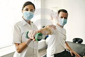 Physiotherapist doing treatment with patient in bright office