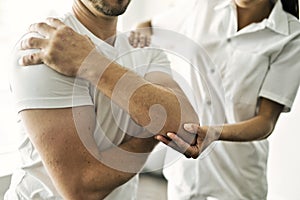 Physiotherapist doing treatment with patient in bright office