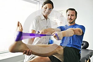 Physiotherapist doing treatment with patient in bright office