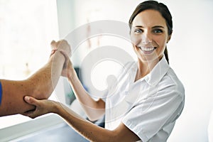 Physiotherapist doing treatment with patient in bright office